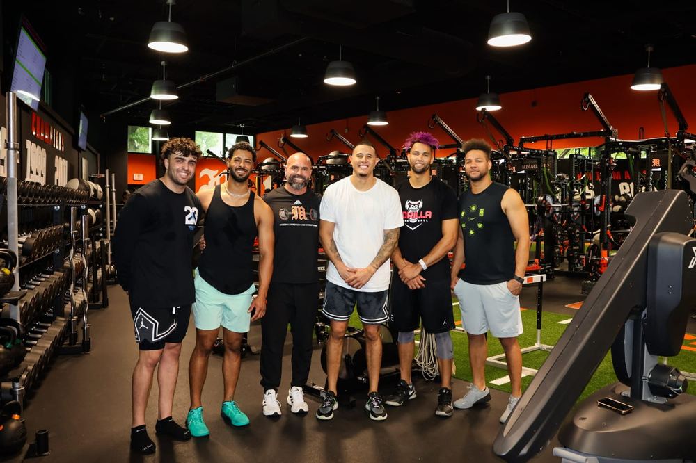 Sal Stewart, MJ Melendez, Nick Soto, Manny Machado, Lourdes Gurriel, and Yuli Gurriel after a training session