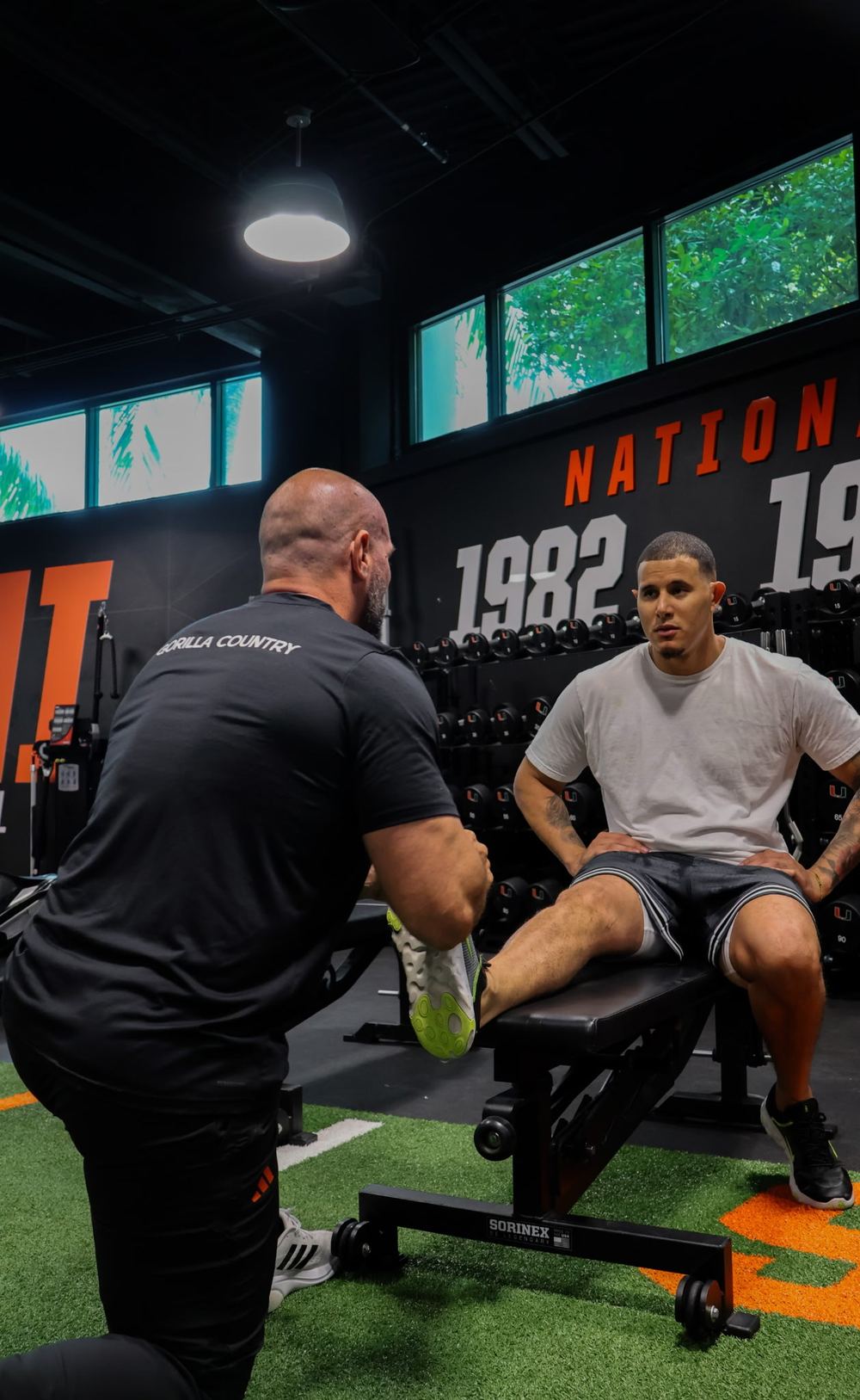Coach coaching an athlete through leg work